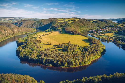 River canyon with dark water and autumn colorful forest. Horseshoe bend, Vltava river, Czech republic. Beautiful landscape with river. Solenice lookout.