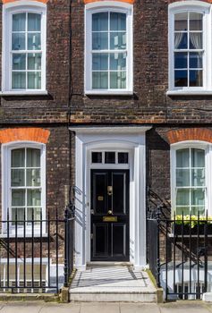 Typical street scene in the central London district with familiar architecture facades to urban housing.