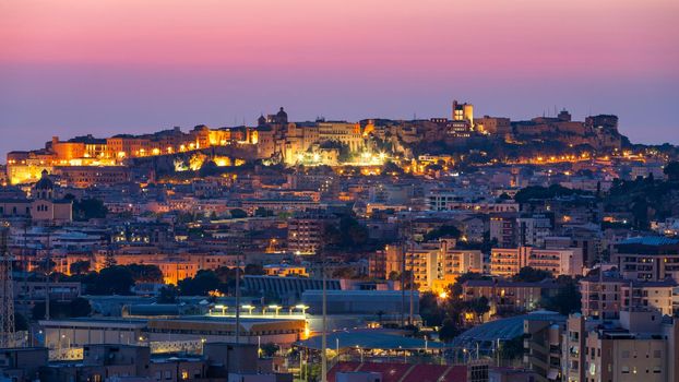 Cagliari cityscape with marina in the Mediterranian sea in the evening, Cagliari, Sardinia, Italy. Sunset on Cagliari, evening panorama of the old city center in Sardinia Capital, Italy
