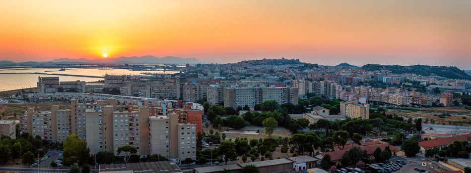 Cagliari cityscape with marina in the Mediterranian sea in the evening, Cagliari, Sardinia, Italy. Sunset on Cagliari, evening panorama of the old city center in Sardinia Capital, Italy
