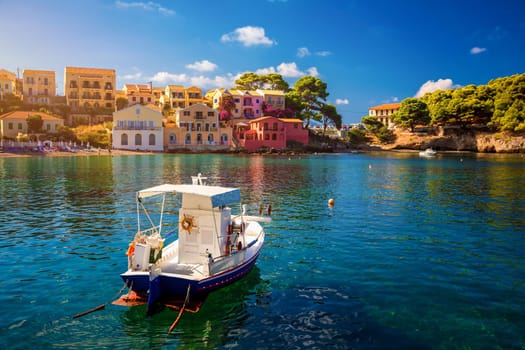 Turquoise colored bay in Mediterranean sea with beautiful colorful houses in Assos village in Kefalonia, Greece. Town of Assos with colorful houses on the mediterranean sea, Greece. 