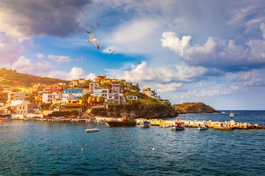 Panorama of Harbour with vessels, boats, beach and lighthouse in Bali at sunrise, Rethymno, Crete, Greece. Famous summer resort in Bali village, near Rethimno, Crete, Greece. 