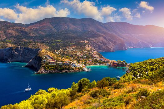 Turquoise colored bay in Mediterranean sea with beautiful colorful houses in Assos village in Kefalonia, Greece. Town of Assos with colorful houses on the mediterranean sea, Greece. 