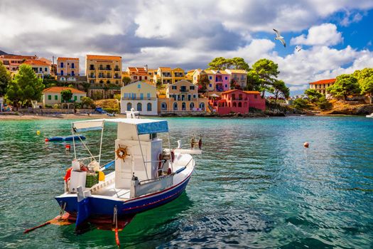 Turquoise colored bay in Mediterranean sea with beautiful colorful houses in Assos village in Kefalonia, Greece. Town of Assos with colorful houses on the mediterranean sea, Greece. 