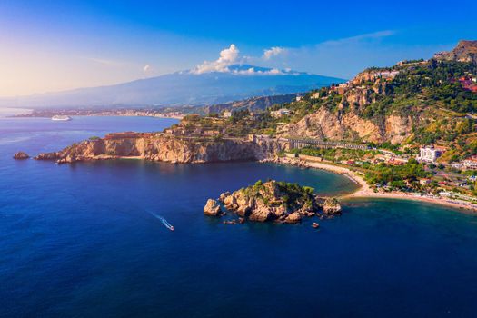 Taormina is a city on the island of Sicily, Italy. Mount Etna over Taormina cityscape, Messina, Sicily. View of Taormina located in Metropolitan City of Messina, on east coast of Sicily island, Italy.