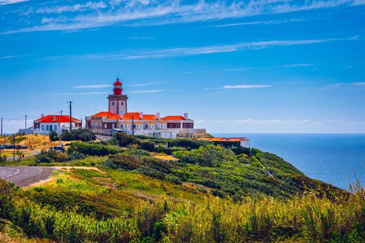 The lighthouse in Cabo da Roca. Cliffs and rocks on the Atlantic ocean coast in Sintra in a beautiful summer day, Portugal. Cabo da Roca, Portugal. Lighthouse and cliffs over Atlantic Ocean.