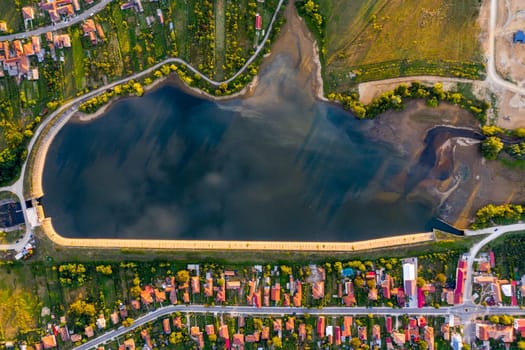 Beautiful Tismana lake and surrounding forest aerial panorama. Tismana, Romania.