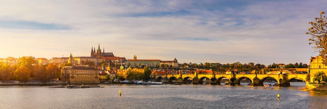 Prague Castle, Charles Bridge and boats on the Vltava river. View of Hradcany Prague Castle, Charles Bridge and a boats on the Vltava river in the capital of the Czechia. Boat cruise on Vltava river.