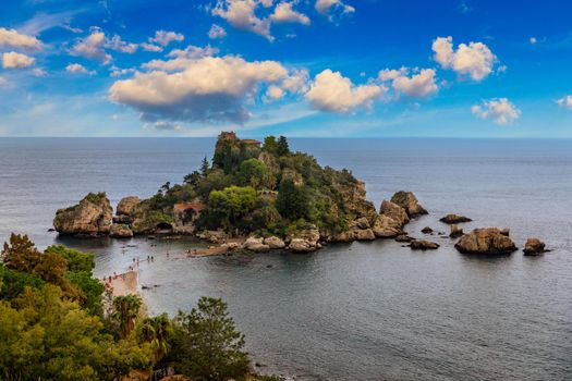 Aerial view of Isola Bella in Taormina, Sicily, Italy. Isola Bella is small island near Taormina, Sicily, Italy. Narrow path connects island to mainland Taormina beach in azure waters of Ionian Sea. 
