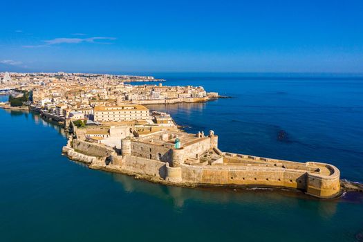 Siracusa, Ortigia Island from the air, Sicily, Italy. Isola di Ortigia, coast of Ortigia island at city of Syracuse, Sicily, Italy. Coastline town Syracuse, Sicily and old Ortigia island. Aerial view.
