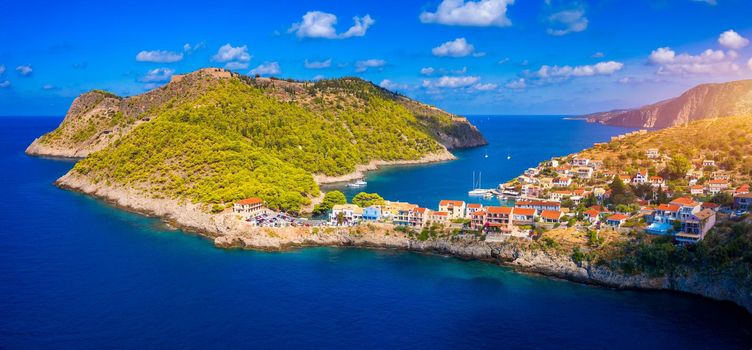Aerial drone view video of beautiful and picturesque colorful traditional fishing village of Assos in island of Cefalonia, Ionian, Greece. Peninsula of Assos in Cephalonia (Kefalonia), Greece