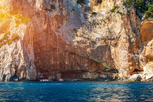 Blue sea and the characteristic caves of Cala Luna, a beach in the Golfo di Orosei, Sardinia, Italy. Big sea caves in the mediterranean coast. Sardinia, Italy.