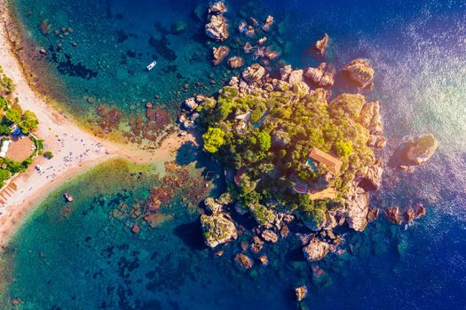 Aerial view of Isola Bella in Taormina, Sicily, Italy. Isola Bella is small island near Taormina, Sicily, Italy. Narrow path connects island to mainland Taormina beach in azure waters of Ionian Sea. 
