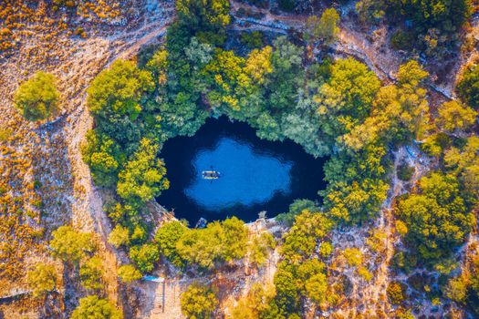 Melissani lake on Kefalonia island, Greece. Melissani Cave (Melissani Lake) near Sami village in Kefalonia island, Greece. Tourist boat on the lake in Melissani Cave, Kefalonia Island, Greece