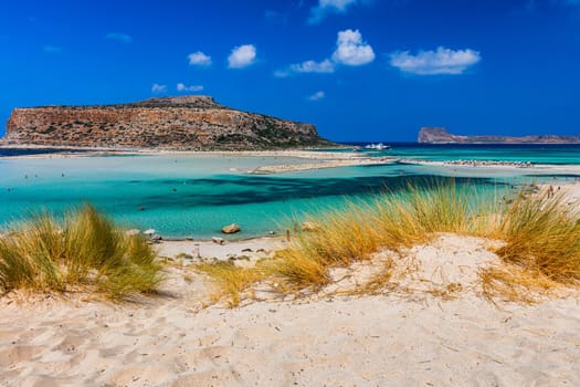Fantastic panorama of Balos Lagoon and Gramvousa island on Crete, Greece. Cap tigani in the center. Balos beach on Crete island, Greece. Tourists relax and bath in crystal clear water of Balos beach.