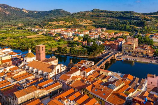 Aerial view of the beautiful village of Bosa with colored houses and a medieval castle. Bosa is located in the north-wesh of Sardinia, Italy. Aerial view of colorful houses in Bosa village, Sardegna.