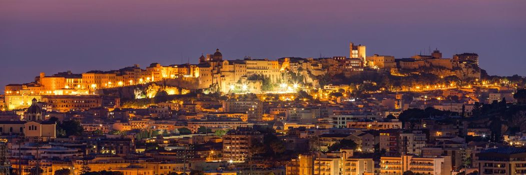Cagliari cityscape with marina in the Mediterranian sea in the evening, Cagliari, Sardinia, Italy. Sunset on Cagliari, evening panorama of the old city center in Sardinia Capital, Italy