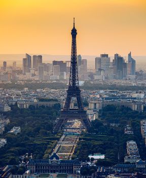 View of Paris with Eiffel Tower from Montparnasse building. Eiffel tower view from Montparnasse at sunset, view of the Eiffel Tower and La Defense district in Paris, France.