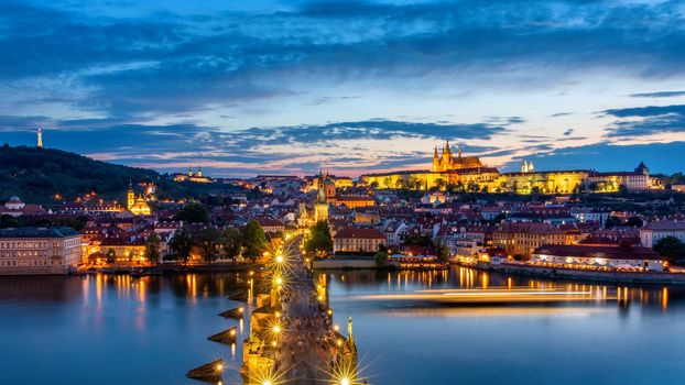 Prague Castle, Charles Bridge and boats on the Vltava river. View of Hradcany Prague Castle, Charles Bridge and a boats on the Vltava river in the capital of the Czechia. Boat cruise on Vltava river.