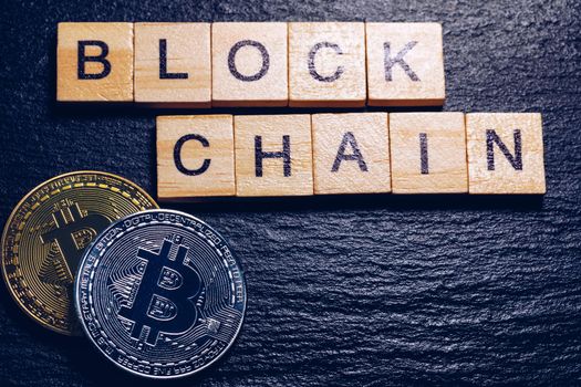 Bitcoins money Virtual currency concept background. Golden bitcoin coin blockchain technology for crypto currency. Digital money currency. Small wooden blocks with block chain text on them.