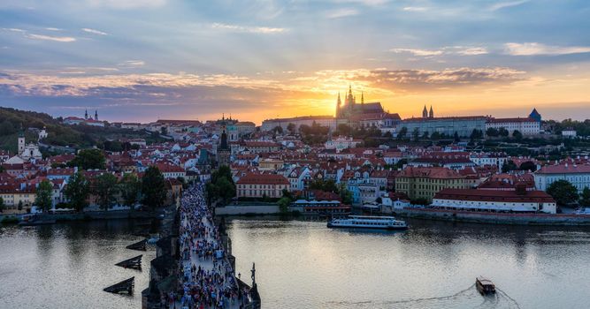 Prague Castle, Charles Bridge and boats on the Vltava river. View of Hradcany Prague Castle, Charles Bridge and a boats on the Vltava river in the capital of the Czechia. Boat cruise on Vltava river.