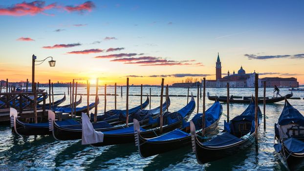 Scenic view of San Giorgio Maggiore, gondolas and lamp at colorful sunrise, Venice, Italy. Sunset in Venice. Gondolas at Saint Mark's Square and church of San Giorgio Maggiore on background, Italy, Europe