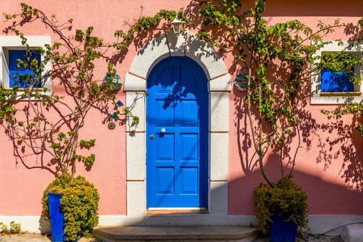Assos village in Kefalonia, Greece. Turquoise colored bay in Mediterranean sea with beautiful colorful houses in Assos village in Kefalonia, Greece, Ionian island, Cephalonia, Assos village.