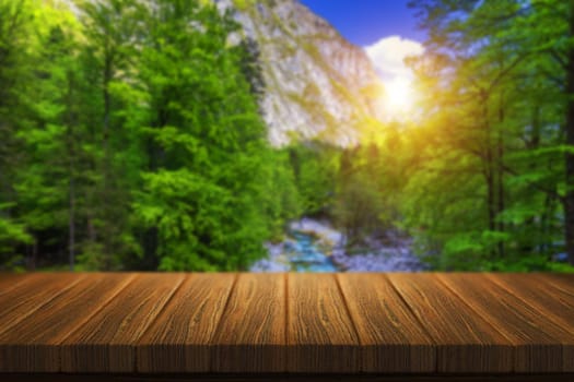 Empty wooden table in front of abstract blurred background in nature, can be used for display or montage your products. Mock up for display of product