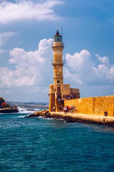 Panorama of venetian harbour waterfront and lighthouse in old harbour of Chania, Crete, Greece. Old venetian lighthouse in Chania, Greece. Lighthouse of the old Venetian port in Chania, Greece.