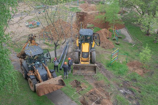 BELARUS, MINSK - MAY 17, 2021: Construction machinery and workers of the emergency brigade. Stock photography.