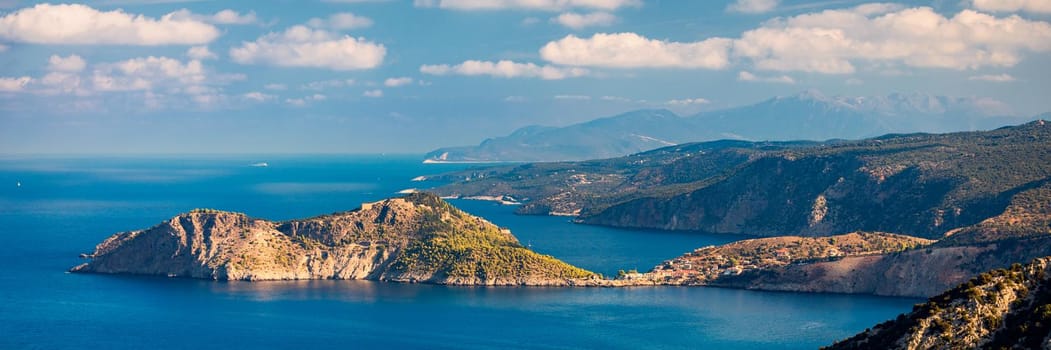 Assos village in Kefalonia, Greece. Turquoise colored bay in Mediterranean sea with beautiful colorful houses in Assos village in Kefalonia, Greece, Ionian island, Cephalonia, Assos village.