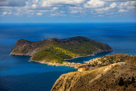 Assos village in Kefalonia, Greece. Turquoise colored bay in Mediterranean sea with beautiful colorful houses in Assos village in Kefalonia, Greece, Ionian island, Cephalonia, Assos village.