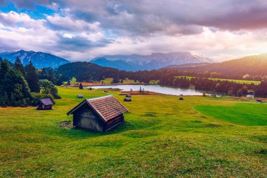 View from flying drone. Astonishing evening view of Wagenbruchsee (Geroldsee) lake with Westliche Karwendelspitze mountain range on background, Bavarian Alps, Germany, Europe.