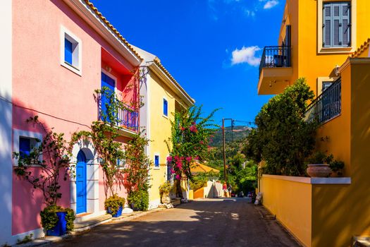 Assos village in Kefalonia, Greece. Turquoise colored bay in Mediterranean sea with beautiful colorful houses in Assos village in Kefalonia, Greece, Ionian island, Cephalonia, Assos village.