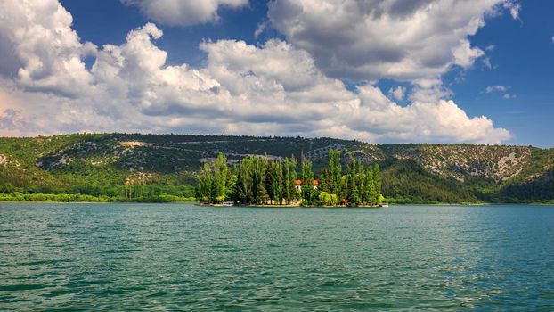 Island of Visovac monastery in Krka national park, Dalmatia, Croatia. Visovac christian monastery on the island in The Krka National park, Croatia.