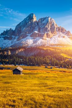 Stunning view of Peitlerkofel mountain from Passo delle Erbe in Dolomites, Italy. View of Sass de Putia (Peitlerkofel) at Passo delle Erbe, with wooden farm houses, Dolomites, South Tyrol, Italy.