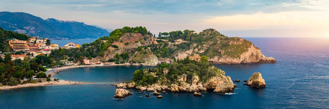 Aerial view of Isola Bella in Taormina, Sicily, Italy. Isola Bella is small island near Taormina, Sicily, Italy. Narrow path connects island to mainland Taormina beach in azure waters of Ionian Sea. 