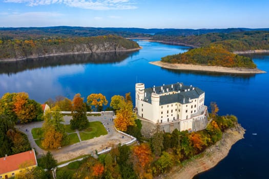 Aerial view chateau Orlik, above Orlik reservoir in beautiful autumn nature. Romantic royal Schwarzenberg castle above water level. Czechia. Orlik castle across the River Vltava, Czech Republic.