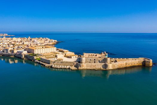 Siracusa, Ortigia Island from the air, Sicily, Italy. Isola di Ortigia, coast of Ortigia island at city of Syracuse, Sicily, Italy. Coastline town Syracuse, Sicily and old Ortigia island. Aerial view.