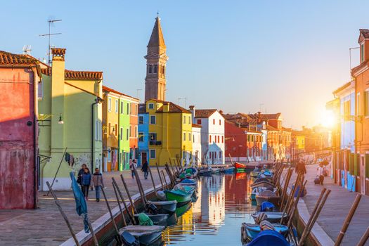 Street with colorful buildings in Burano island, Venice, Italy. Architecture and landmarks of Burano, Venice postcard. Scenic canal and colorful architecture in Burano island near Venice, Italy