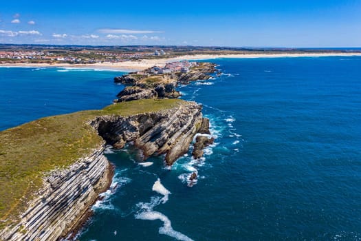 Aerial view of island Baleal naer Peniche on the shore of the ocean in west coast of Portugal. Baleal Portugal with incredible beach and surfers. Aerial view of Baleal, Portugal.