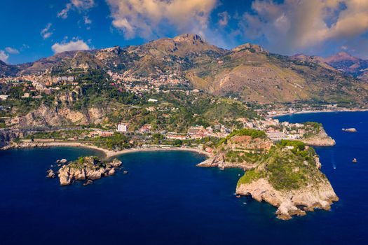 Taormina is a city on the island of Sicily, Italy. Mount Etna over Taormina cityscape, Messina, Sicily. View of Taormina located in Metropolitan City of Messina, on east coast of Sicily island, Italy.