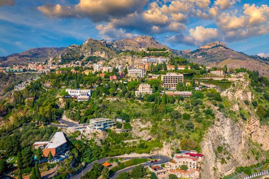 Taormina is a city on the island of Sicily, Italy. Mount Etna over Taormina cityscape, Messina, Sicily. View of Taormina located in Metropolitan City of Messina, on east coast of Sicily island, Italy.