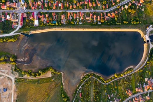 Beautiful Tismana lake and surrounding forest aerial panorama. Tismana, Romania.