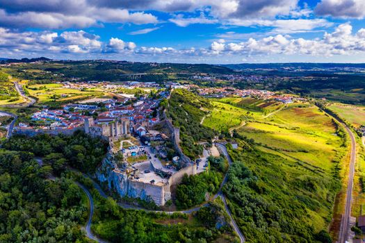 Aerial view of the historic walled town of Obidos at sunset, near Lisbon, Portugal. Aerial shot of Obidos Medieval Town, Portugal. Aerial view of medieval fortress in Obidos. Portugal.