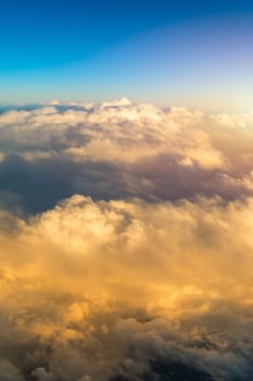 Sunny sky abstract background, beautiful cloudscape, on the heaven, view over white fluffy clouds, freedom concept. Aerial view of sky and white clouds. View from airplane. 