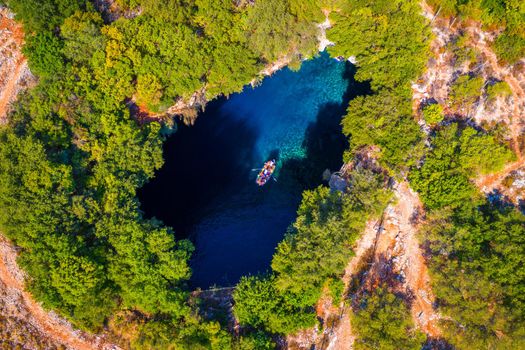 Melissani lake on Kefalonia island, Greece. Melissani Cave (Melissani Lake) near Sami village in Kefalonia island, Greece. Tourist boat on the lake in Melissani Cave, Kefalonia Island, Greece