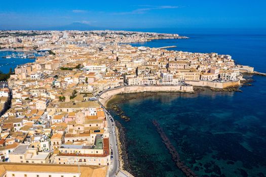 Siracusa, Ortigia Island from the air, Sicily, Italy. Isola di Ortigia, coast of Ortigia island at city of Syracuse, Sicily, Italy. Coastline town Syracuse, Sicily and old Ortigia island. Aerial view.