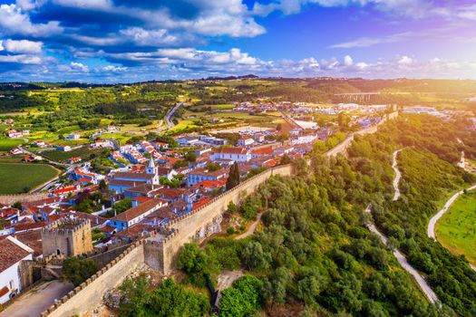 Aerial view of the historic walled town of Obidos at sunset, near Lisbon, Portugal. Aerial shot of Obidos Medieval Town, Portugal. Aerial view of medieval fortress in Obidos. Portugal.