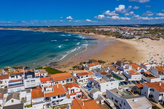 Aerial view of island Baleal naer Peniche on the shore of the ocean in west coast of Portugal. Baleal Portugal with incredible beach and surfers. Aerial view of Baleal, Portugal.